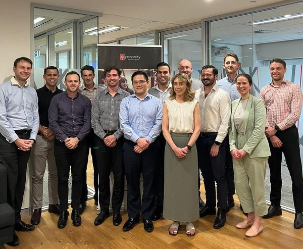 Group of young professionals posing for photo in office